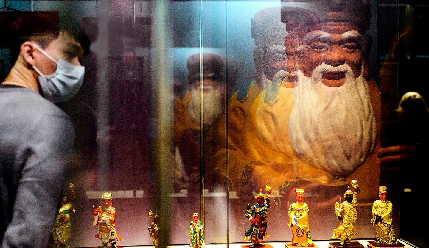 桃園市土地公文化館內，玻璃反射的多個且重疊形象，像是由單一化身多元神職，宛如我們對於土地公的認識。(攝影／安培淂)
