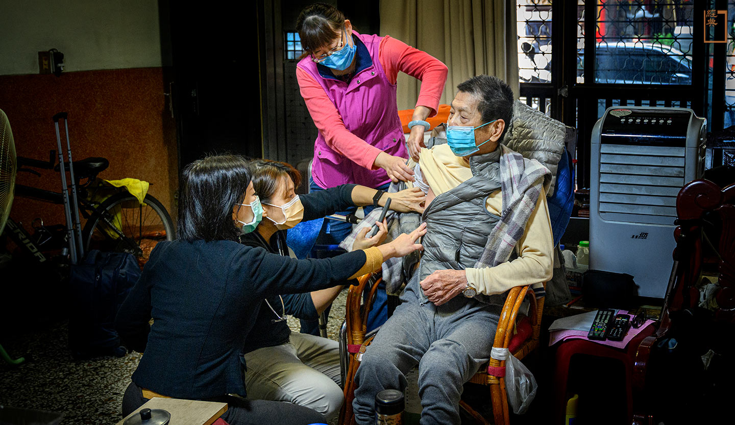 宏美德生診所醫師陳蕙雅與日日福居家護理所護理師曾士嬴，正在八十八歲、罹患淋巴癌的簡阿公家中，觀察他皮膚搔癢狀況。(攝影／安培淂)