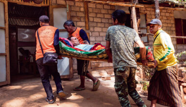 一名在緬甸軍隊空襲中受傷的平民被抬進隱藏在樹林間，用竹子搭建、後來才有水泥補強的祕密醫院，平均每個月處理一百人次因內戰創傷的手術。(攝影／Thierry Falise)